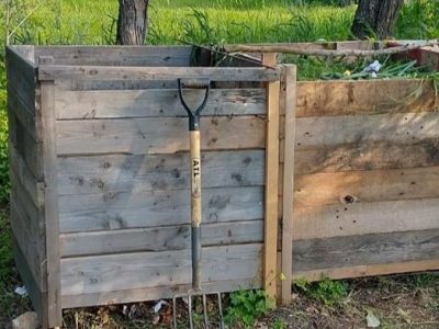 Pitch fork next to some wooden compost bays