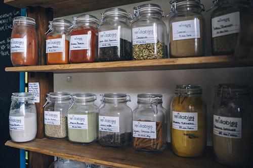 Refillable jars of spices on shelves