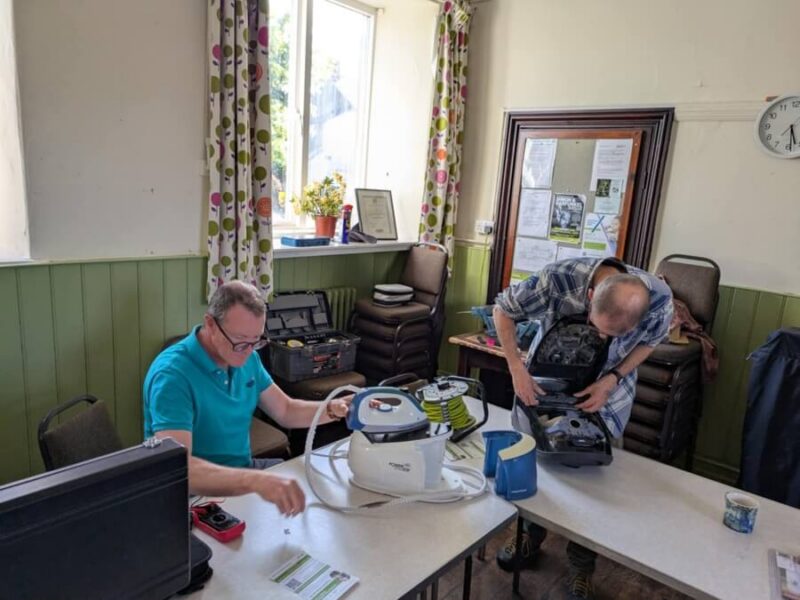 Volunteers repairing electronics at Staveley Repair Cafe