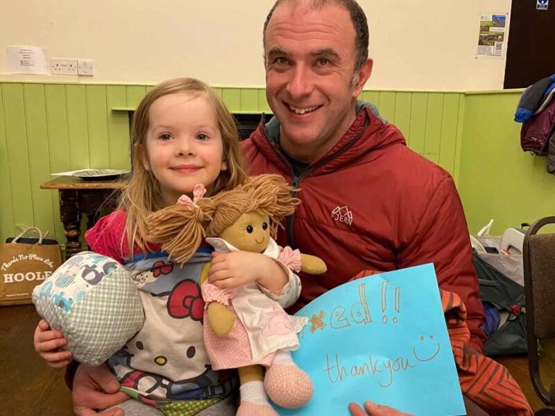 People holding repaired toys from Staveley Repair Cafe