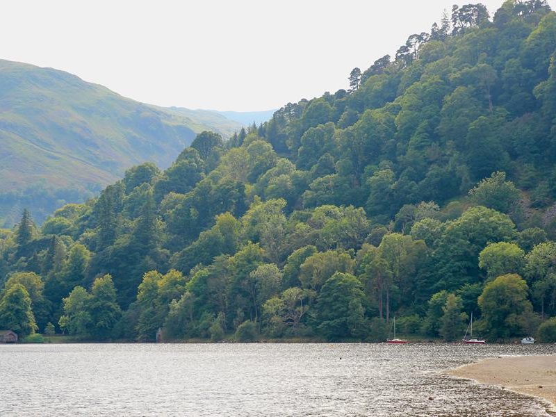 Ullswater with woodland and mountains in the background