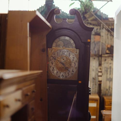 Vintage grandfather clock in a furniture shop